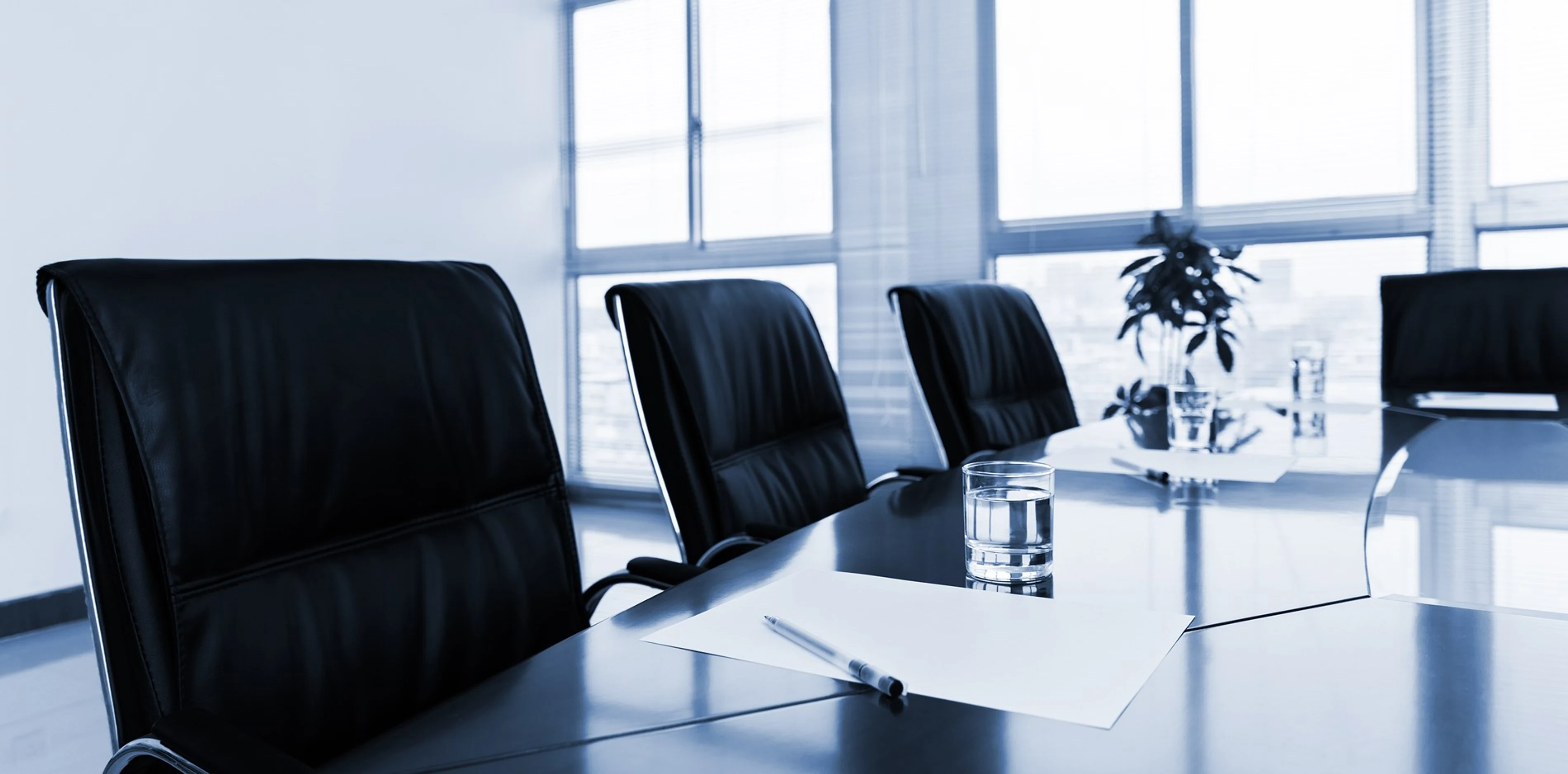 Empty boardroom with conference table and chairs
